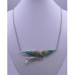 A plique a jour bird necklace. The pendant 8.5 cm wide.