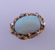 A vintage cabochon cut opal and diamond ring. The opal 4 carats. Ring size R. 10.