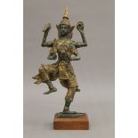 A Thai patinated bronze model of a dancing four-armed deity. 27 cm high.