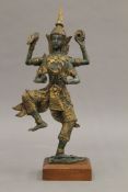 A Thai patinated bronze model of a dancing four-armed deity. 27 cm high.