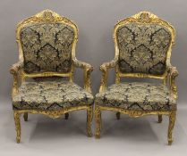 A pair of 19th century gilt framed upholstered open armchairs. 75 cm wide.