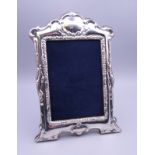 A silver photograph frame. 21 cm high.
