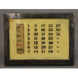 A silver desk calendar. 15 cm wide.