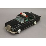 A Japanese tin plate Mercedes taxi, with opening doors and flashing top light. 25.5 cm long.