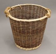 A log basket. 63 cm high, the top 55 cm diameter.