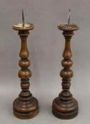 A pair of turned wooden candlesticks. 48.5 cm high.