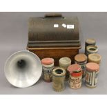 A Thomas A Edison oak cased phonograph with horn; together with a selection of phonograph rolls. 32.