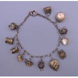 A unmarked gold bracelet with twelve silver gilt and enamelled charms. Approximately 18 cm long.