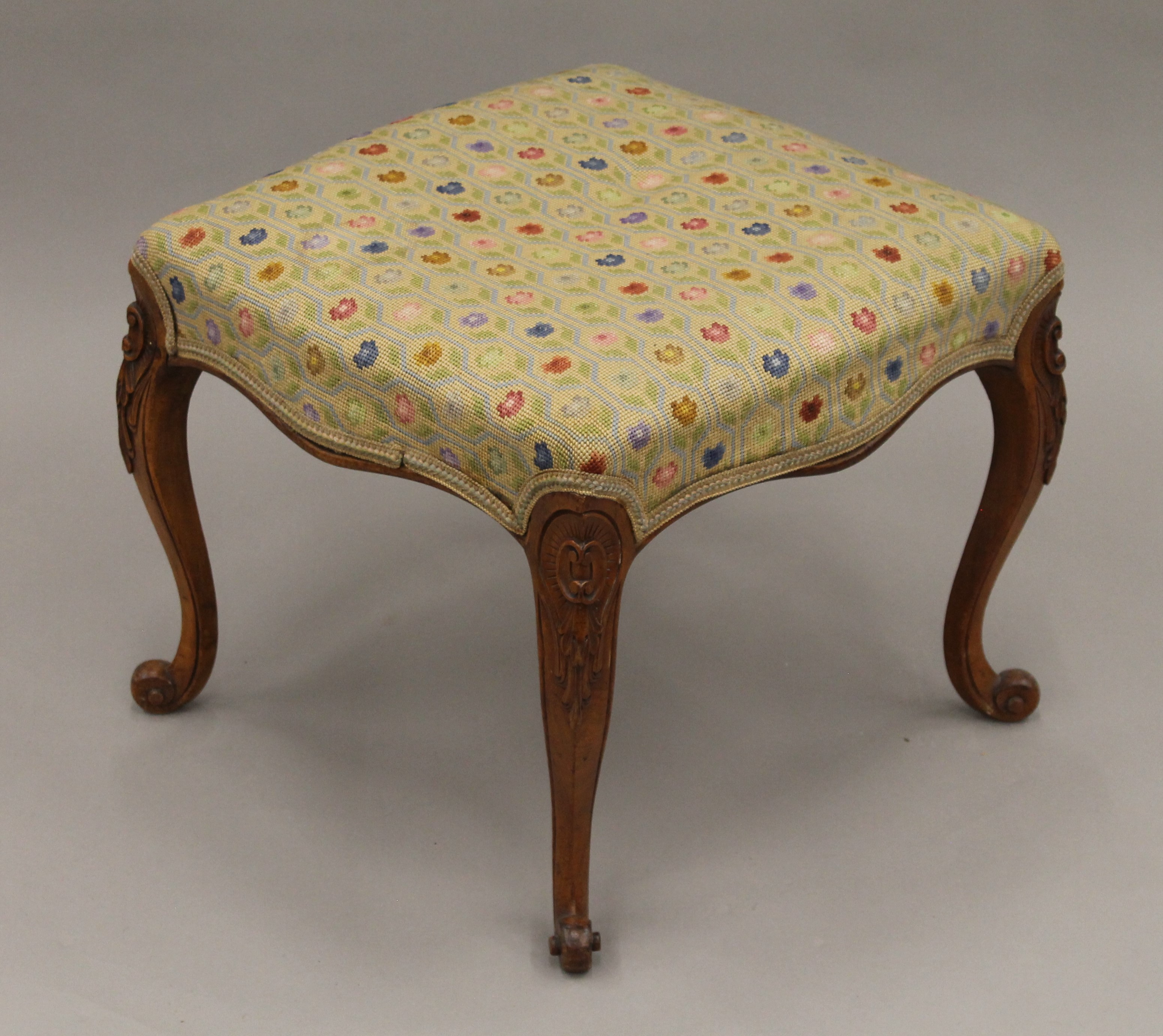A Victorian tapestry upholstered walnut stool. 52.5 cm wide.