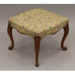 A Victorian tapestry upholstered walnut stool. 52.5 cm wide.