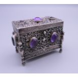 A Continental 800 silver box set with amethyst and agate cabochons. 5.5 cm high.