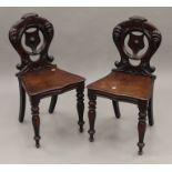 A pair of Victorian mahogany hall chairs. 43.5 cm wide.