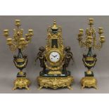 An ornate clock garniture. The clock 61 cm high.