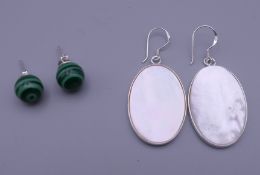 Two pairs of silver earrings.