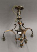 A copper chandelier with three glass shades. 45 cm high.