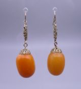 A pair of antique butterscotch amber earrings. Approximately 12.9 grammes total weight.