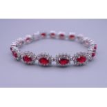 A 925 silver and rhodium plated synthetic ruby and diamond bracelet. 17.5 cm long.
