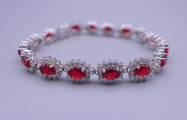 A 925 silver and rhodium plated synthetic ruby and diamond bracelet. 17.5 cm long.