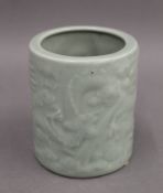 A Chinese celadon porcelain brush pot. 12 cm high.