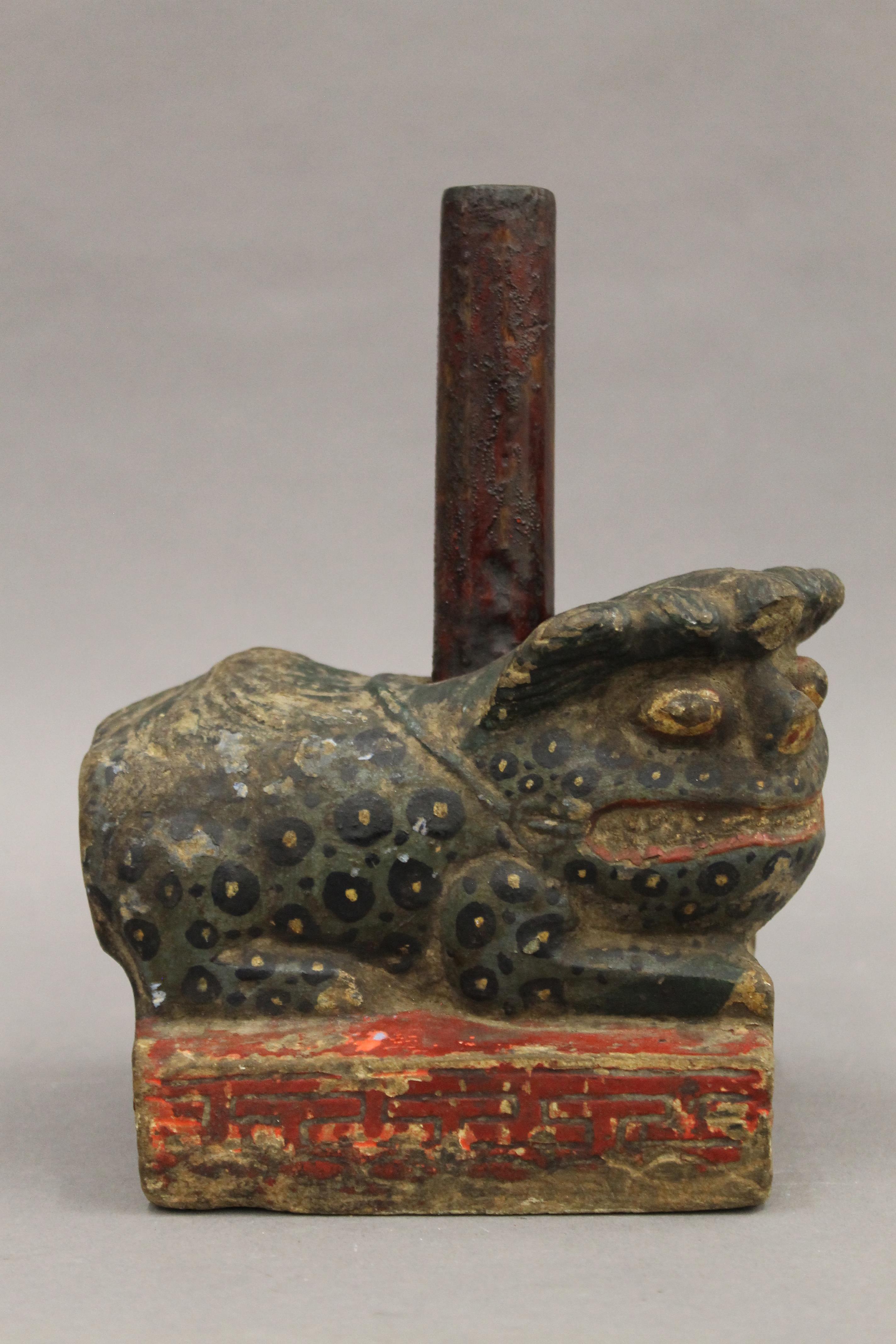 A 19th century Chinese painted carved stone dog-of-fo form incense holder. 15 cm long.