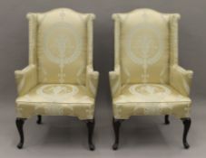 A pair of mahogany framed wing back armchairs. Each 76 cm wide.