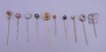 A quantity of antique stickpins. The largest 7.5 cm high.