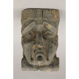 An early carved oak grotesque mask, possibly 17th century or earlier. 23 cm high.
