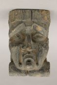 An early carved oak grotesque mask, possibly 17th century or earlier. 23 cm high.