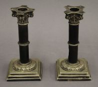 A pair of silver plate mounted candlesticks. 15 cm high.