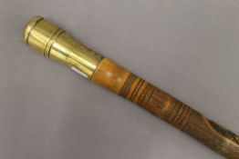 A Japanese carved bamboo walking stick, the brass handle set with a compass. 94.5 cm high.