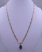 A 9 K gold chain set with diamond and sapphire pendant. 7.9 grammes total weight.