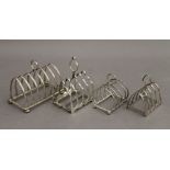 Four silver toast racks. The largest 12.5 cm wide. 11.6 troy ounces.