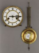 A clock movement and pendulum. 14.5 cm diameter.