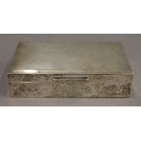 A silver cigarette box. 14.25 cm wide. 12.1 troy ounces total weight.