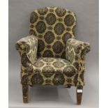 An early 20th century child's upholstered arm chair. 56 cm wide.