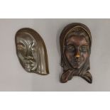An Art Deco porcelain wall mask and another. The former 23 cm high.