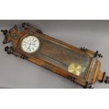 A walnut cased Vienna regulator wall clock. 135 cm high.