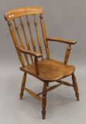 A Victorian elm seated stick back armchair. 56.5 cm wide.