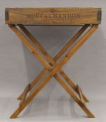 A wooden tray on stand. 65 cm wide.