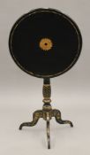 A 19th century chinoiserie tilt top tripod table. 49.5 cm diameter.