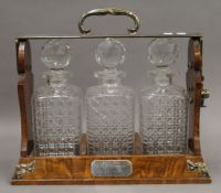 A Victorian Bejtemann's patent silver plate mounted oak three bottle tantalus. 36 cm wide.