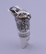A silver whistle formed as a hare. 4.5 cm high.