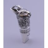 A silver whistle formed as a hare. 4.5 cm high.