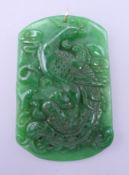 A gold mounted carved apple green jade pendant. 6.5 cm high.