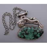 A large Oriental silver and turquoise pendant on a sterling silver chain. The pendant 7 cm wide.