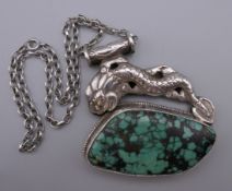 A large Oriental silver and turquoise pendant on a sterling silver chain. The pendant 7 cm wide.