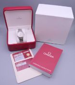 A boxed Omega De Ville stainless steel wristwatch, with paperwork. 3.5 cm wide.