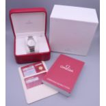 A boxed Omega De Ville stainless steel wristwatch, with paperwork. 3.5 cm wide.