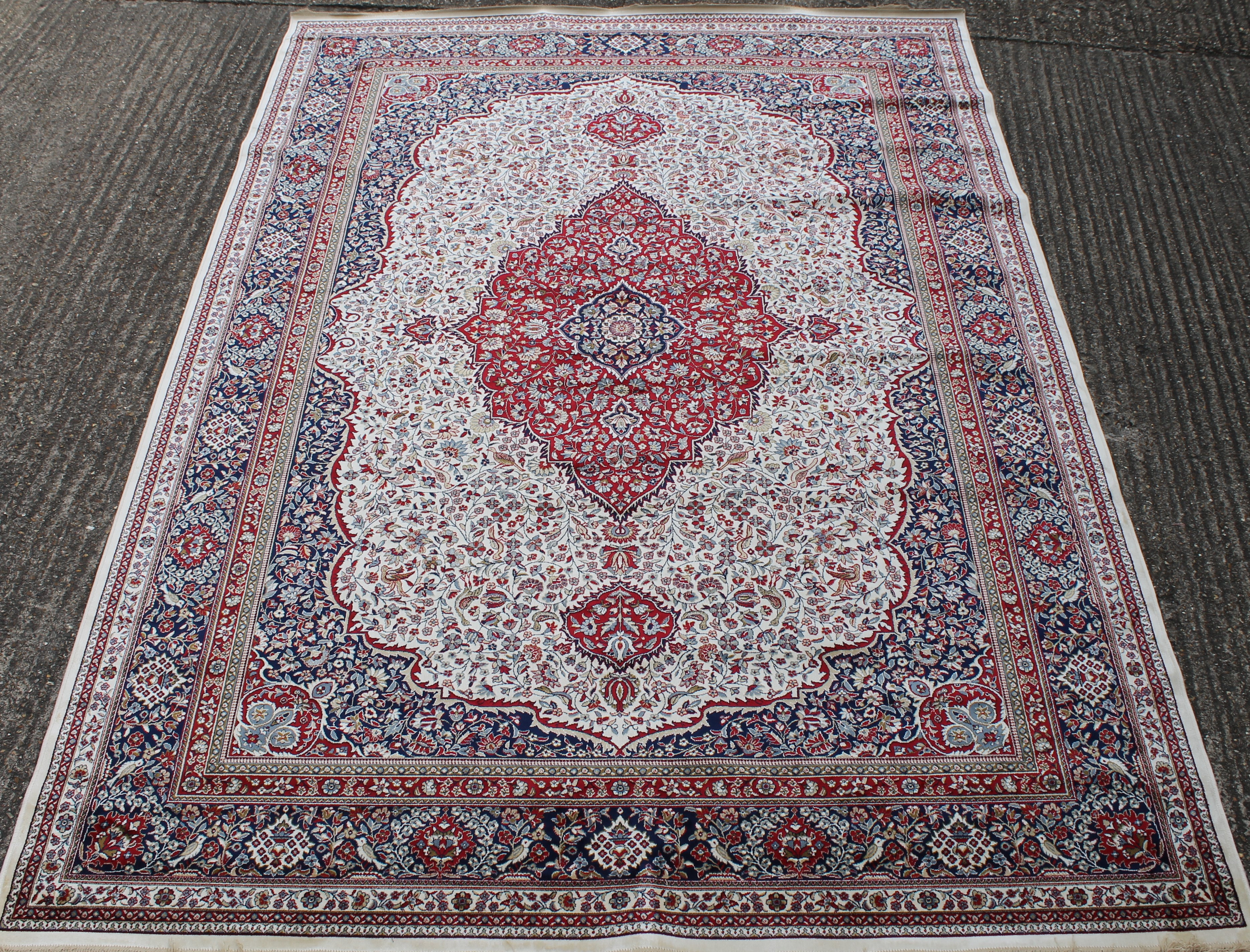 An ivory ground full pile Kashmir traditional medallion rug. 330 x 240 cm.