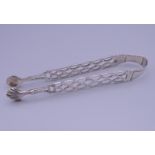 A pair of 18th century silver sugar tongs, possibly by maker John Schofield. 13.5 cm long.